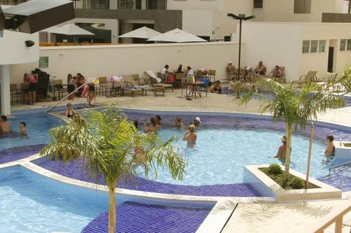 a group of people in a swimming pool at Prive Atrium Thermas Residence in Caldas Novas