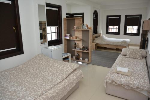 a bedroom with two beds and a room with a mirror at Villa Dudanov in Ohrid