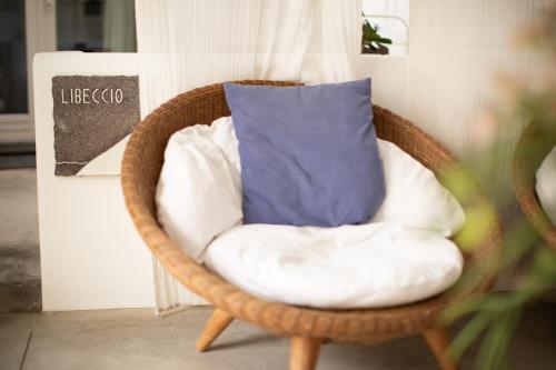 a wicker chair with a pillow in a room at Il Gabbiano Relais in Stromboli in Stromboli