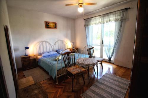 a bedroom with a bed and a table and chairs at Green garden apartments in Rovinj
