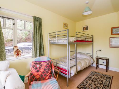 a bedroom with a bunk bed and a couch at Tower Lodge in Dalmally