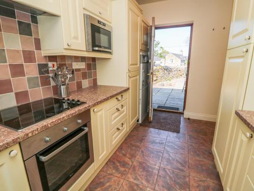 a kitchen with a sink and a microwave at Gowanlea in Hexham