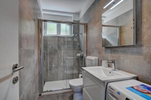 a bathroom with a shower and a toilet and a sink at Apartman D in Pula