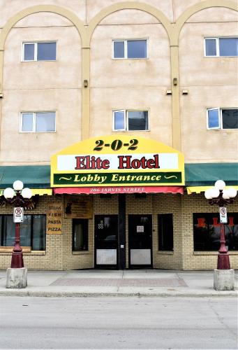 a large building with aire hotel luxury entrance at Elite Hotel -Downtown Center- "Ski & Northern light Tour" "Hot Spring Tour "Long-term stay" in Whitehorse
