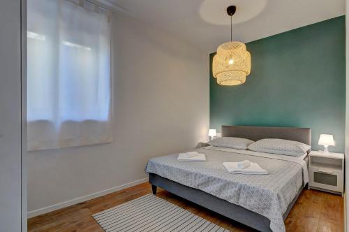 a bedroom with a bed and a large window at Apartman D in Pula