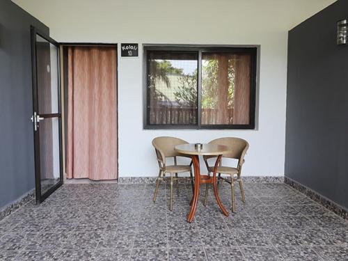 a table and chairs in a room with a window at Senegambia Beach Hotel in Kololi