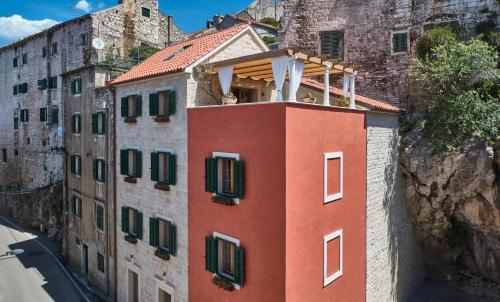 a building with a balcony on top of it at Villa Pergola in Šibenik