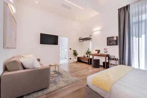 a bedroom with a bed and a living room at La Spezia by The First - Luxury Rooms & Suites in La Spezia