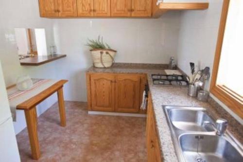 a kitchen with a sink and a counter top at Can Tauet de ses Roques in Playa Migjorn