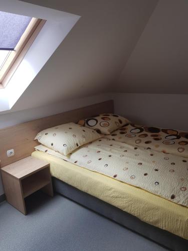 a small bedroom with a bed with a window at Willa Maria in Łagów