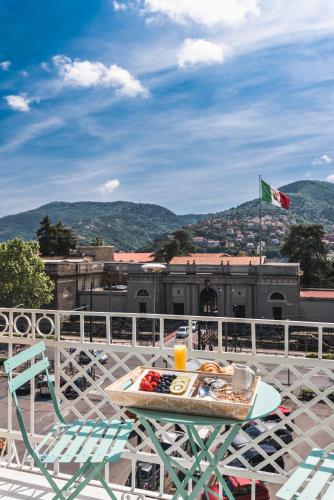 a table and chairs on a balcony with a flag at La Spezia by The First - Luxury Rooms & Suites in La Spezia