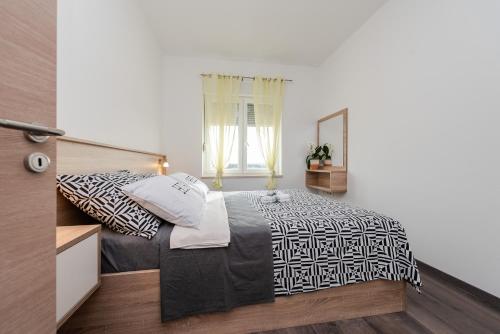 a bedroom with a bed and a window at Villa Luka in Zadar
