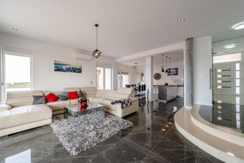 a living room with a couch and a table at Villa Luka in Zadar