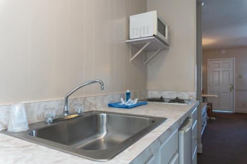 a kitchen with a stainless steel kitchen sink at The Admiral Hotel/Motel in Ocean City