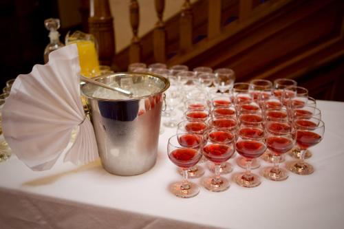 a row of wine glasses on a table with a bucket at Ramnee Hotel in Forres
