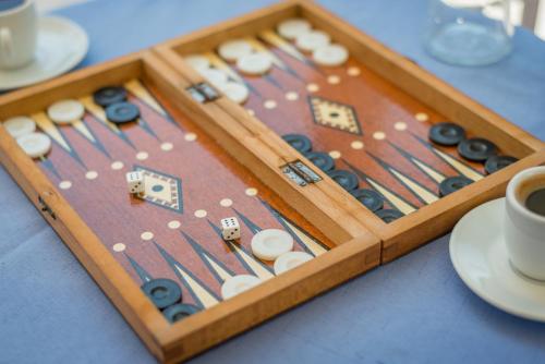 a wooden tray with dominoes and buttons on a table at Vira Vivere Houses in Plaka Milou