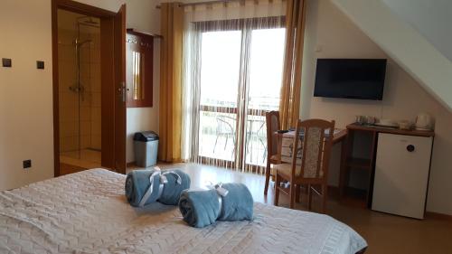 a bedroom with two blue bags on a bed at Villa Kapitańska in Kołobrzeg