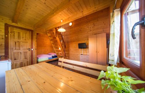 a wooden room with a wooden table in a cabin at Domki FALA in Międzywodzie
