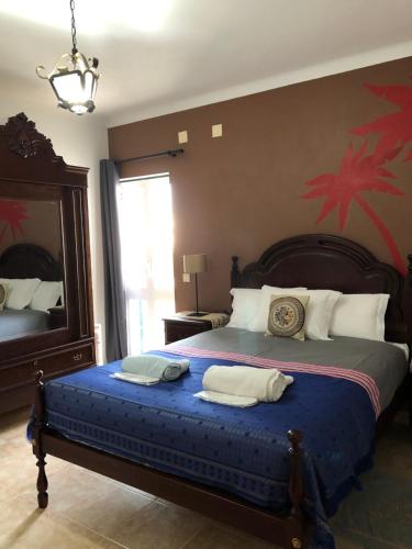 a bedroom with a large bed with two pillows on it at Villa Do Mar SW in Zambujeira do Mar