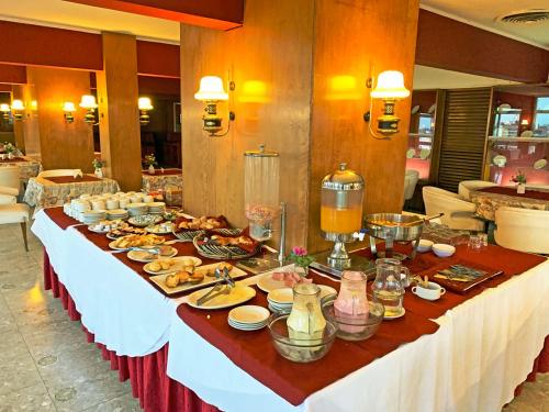 
a table with plates of food on it at Hotel Sussex in Córdoba
