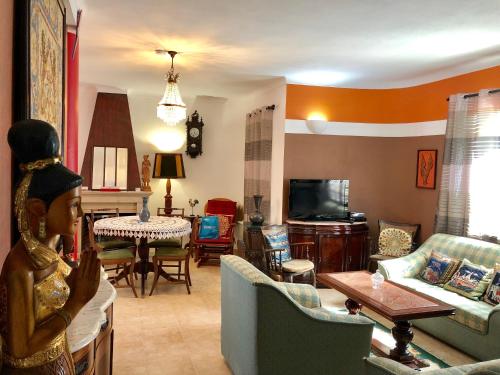 a living room with a couch and a dining room at Villa Do Mar SW in Zambujeira do Mar