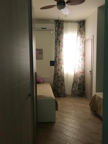 a bedroom with a bed and a ceiling fan at B&B Stella del Mare in Lampedusa