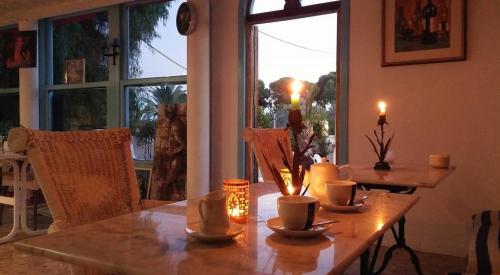 a wooden table with candles on it in a room with a window at El Artista in Villajoyosa