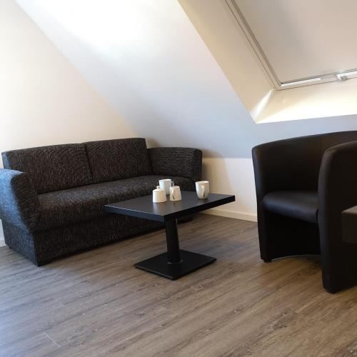 a living room with a couch and a coffee table at Haus Worch in Juist