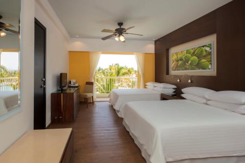 a hotel room with two beds and a window at Krystal Grand Nuevo Vallarta in Nuevo Vallarta 