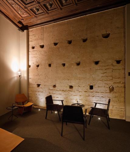 a room with chairs and a brick wall at Caro Hotel in Valencia