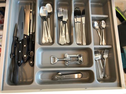a drawer filled with silver utensils and utensils at Ferienwohnung Villa Josephine in Badenweiler