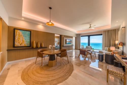a living room with a table and chairs at Haven Riviera Cancun - All Inclusive - Adults Only in Cancún