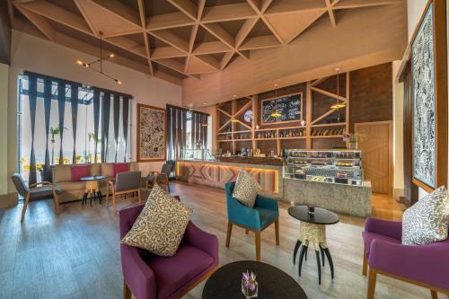 a lobby with purple furniture and a bar at Haven Riviera Cancun - All Inclusive - Adults Only in Cancún