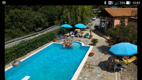 an overhead view of a swimming pool with umbrellas at Bed & Breakfast Laino in Maratea