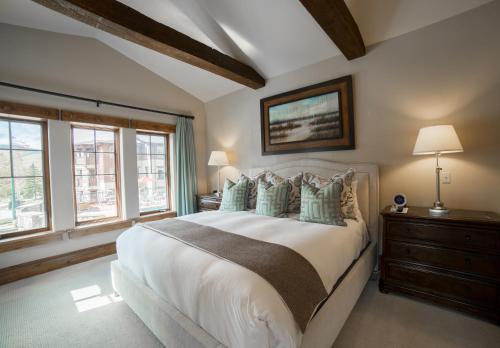a bedroom with a large white bed and windows at The Chateaux Deer Valley in Park City