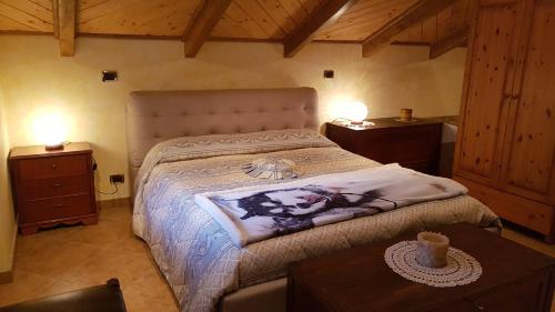 a bedroom with a bed and two night stands at Il Riposo Del guerriero in Corio