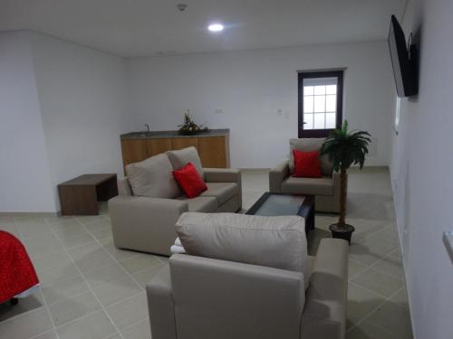 a living room with two couches and a tv at Cidadelhe Rupestre Turismo Rural in Cidadelhe