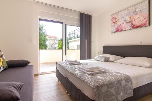 a bedroom with a large bed with a table at Apartments Edi & Tea in Malinska
