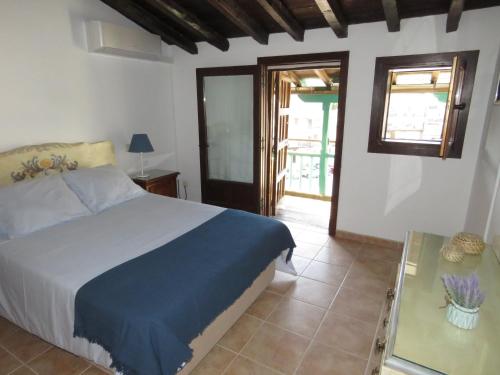 1 dormitorio con cama y mesa de cristal en Villa Elisa Plaza Mayor, en Chinchón
