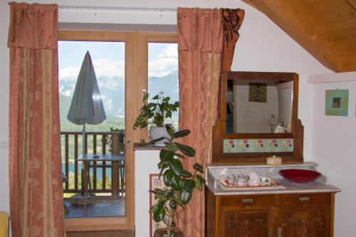 a kitchen with a sink and a view of a balcony at B&B Alba Sul Lago in Pergine Valsugana