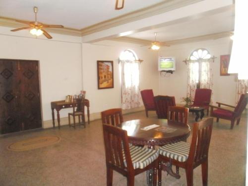a dining room with a table and chairs at Asmini Palace Hotel in Zanzibar City
