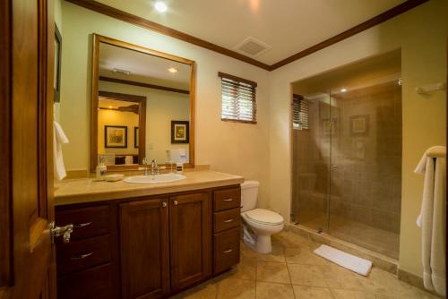 a bathroom with a toilet and a sink and a shower at Los Suenos Resort Veranda 6D in Herradura