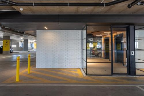 an empty parking lot with a glass door in a parking garage at Brand new penthouse with waterfront views in Cape Town