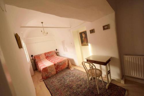 a bedroom with a bed and a table and a desk at BARBARA RESIDENZ - APARTMENT CALLA in Eisenerz