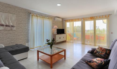 een woonkamer met een bank en een tafel bij Apartments Dora Victoria Dream in Medulin
