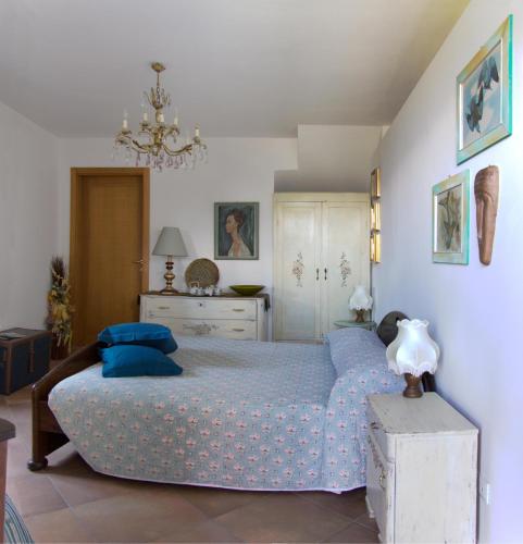 a bedroom with a bed with a blue comforter at B&B Alba Sul Lago in Pergine Valsugana