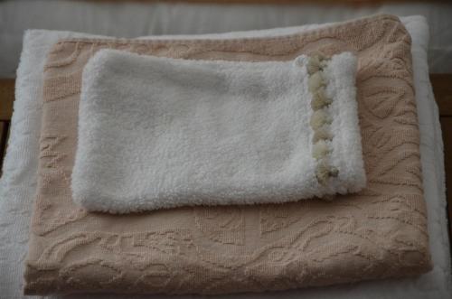 a close up of a white towel on a bed at Les Chambres d'Hôtes du Grand Mornas in Carry-le-Rouet