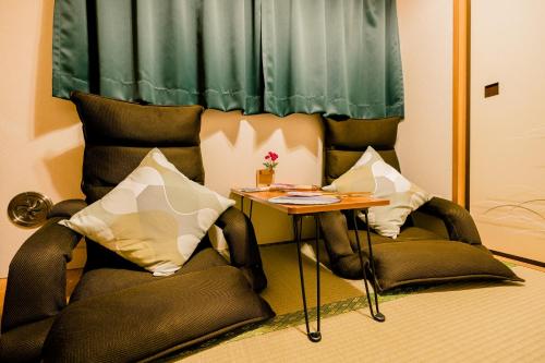 a living room with two chairs and a table at Bunkyo-ku Hakusan House in Tokyo