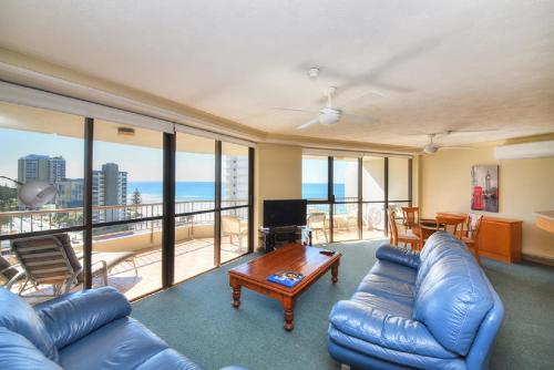a living room with a couch and a table at Bougainvillea Gold Coast Holiday Apartments in Gold Coast