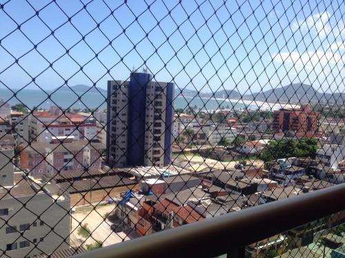 a view of a city from a fence at Apartamento Guaruja in Guarujá